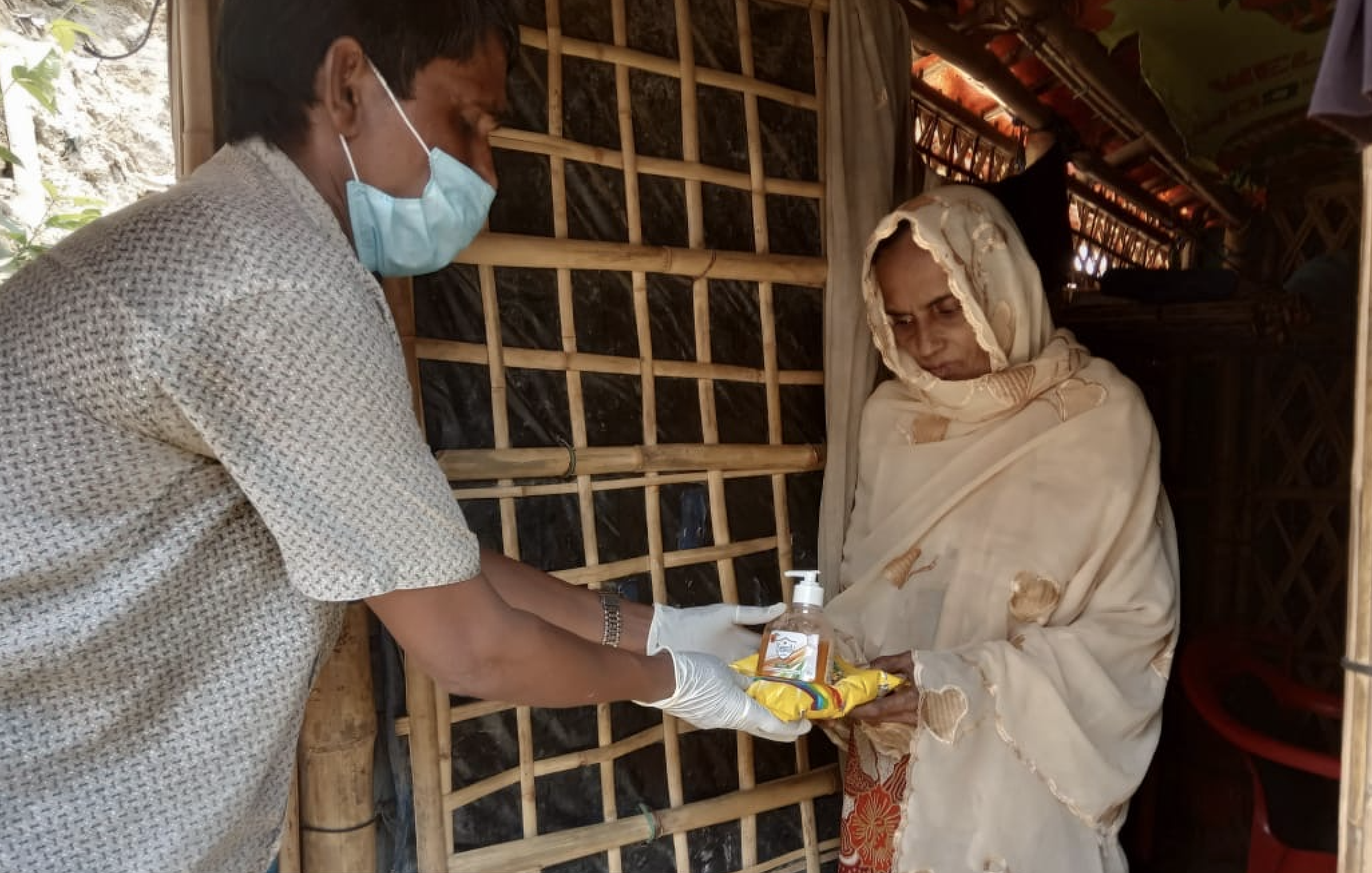 A health worker handing out antibacterial gel and other equipment to at risk older people in the communities during the coronavirus crisis