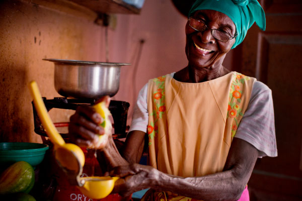 Ernestina juices fruit for her drinks, which she sells to schoolchildren. 